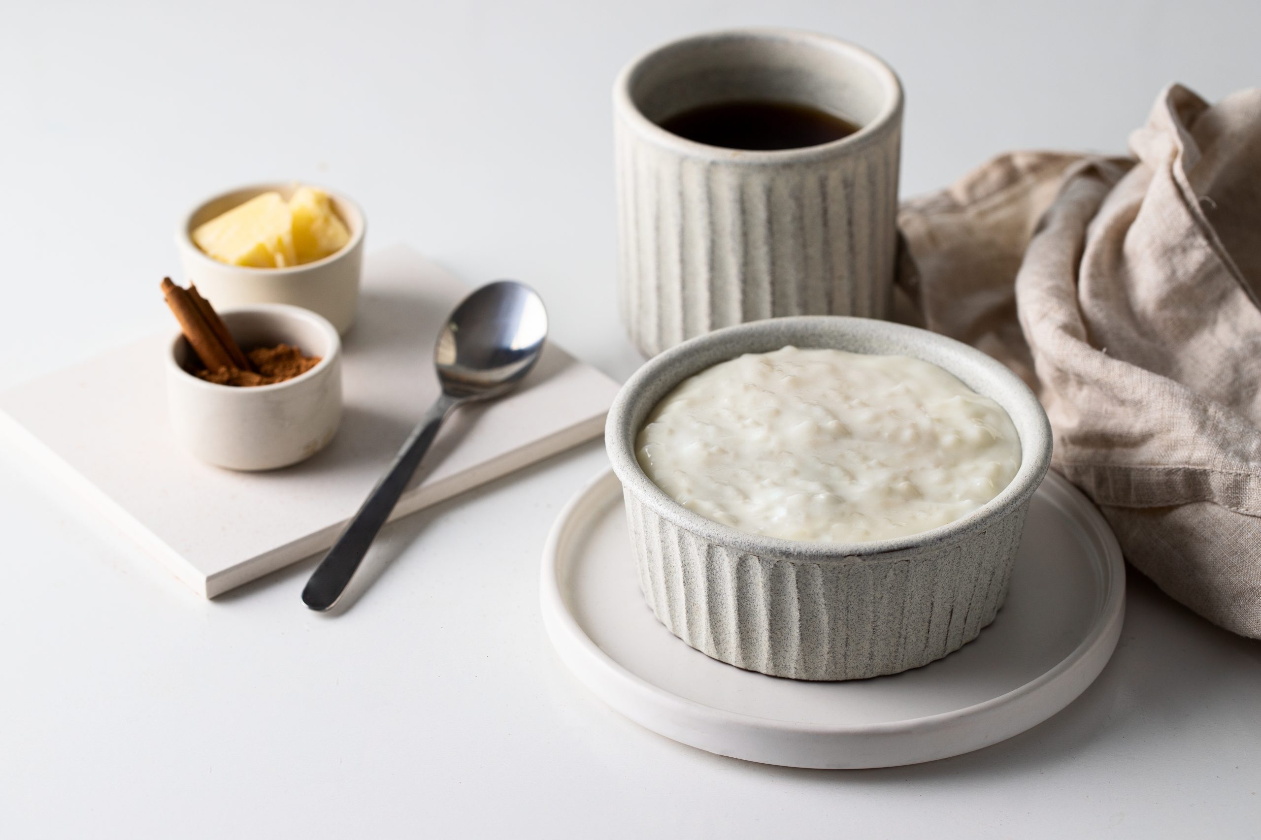Scandinavian,Rice,Porridge,On,Grey,Ceramic,Bowl,Served,With,Butter