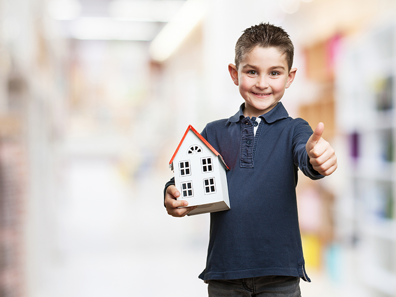 little kid holding a house