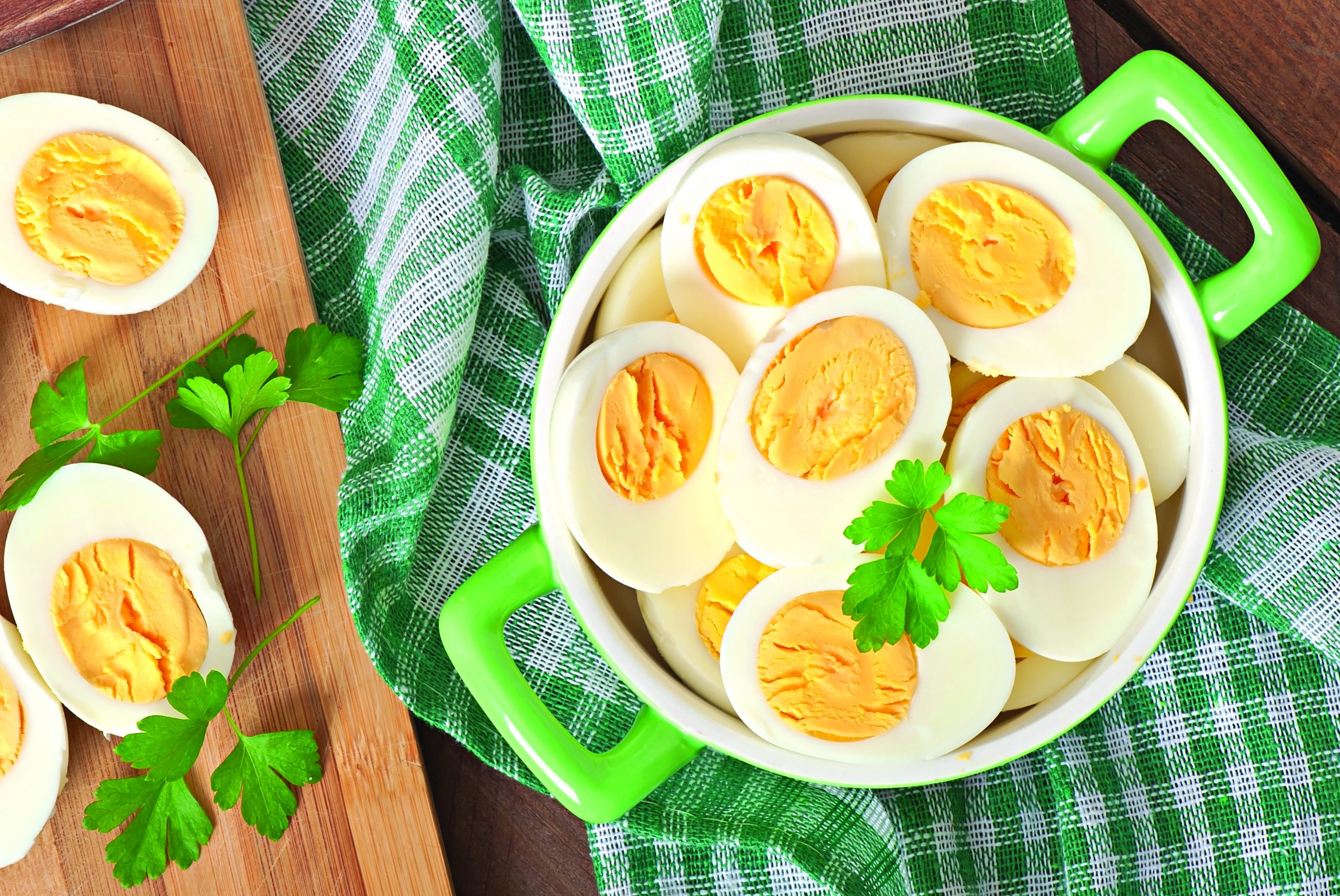 Boiled eggs in a bowl decorated with parsley leaves