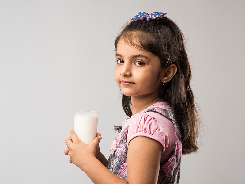 Cute,Little,Indian/asian,Girl,Holding,A,Glass,Full,Of,Milk