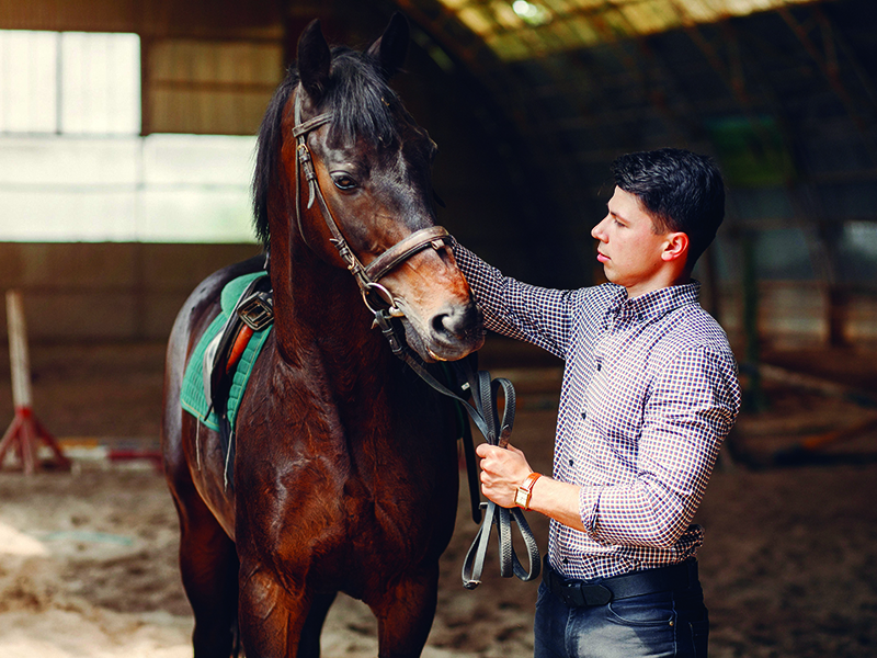 Handsome man standing in a ranch